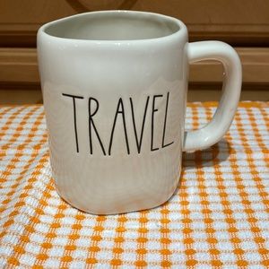 Rae Dunn mug with “travel” text